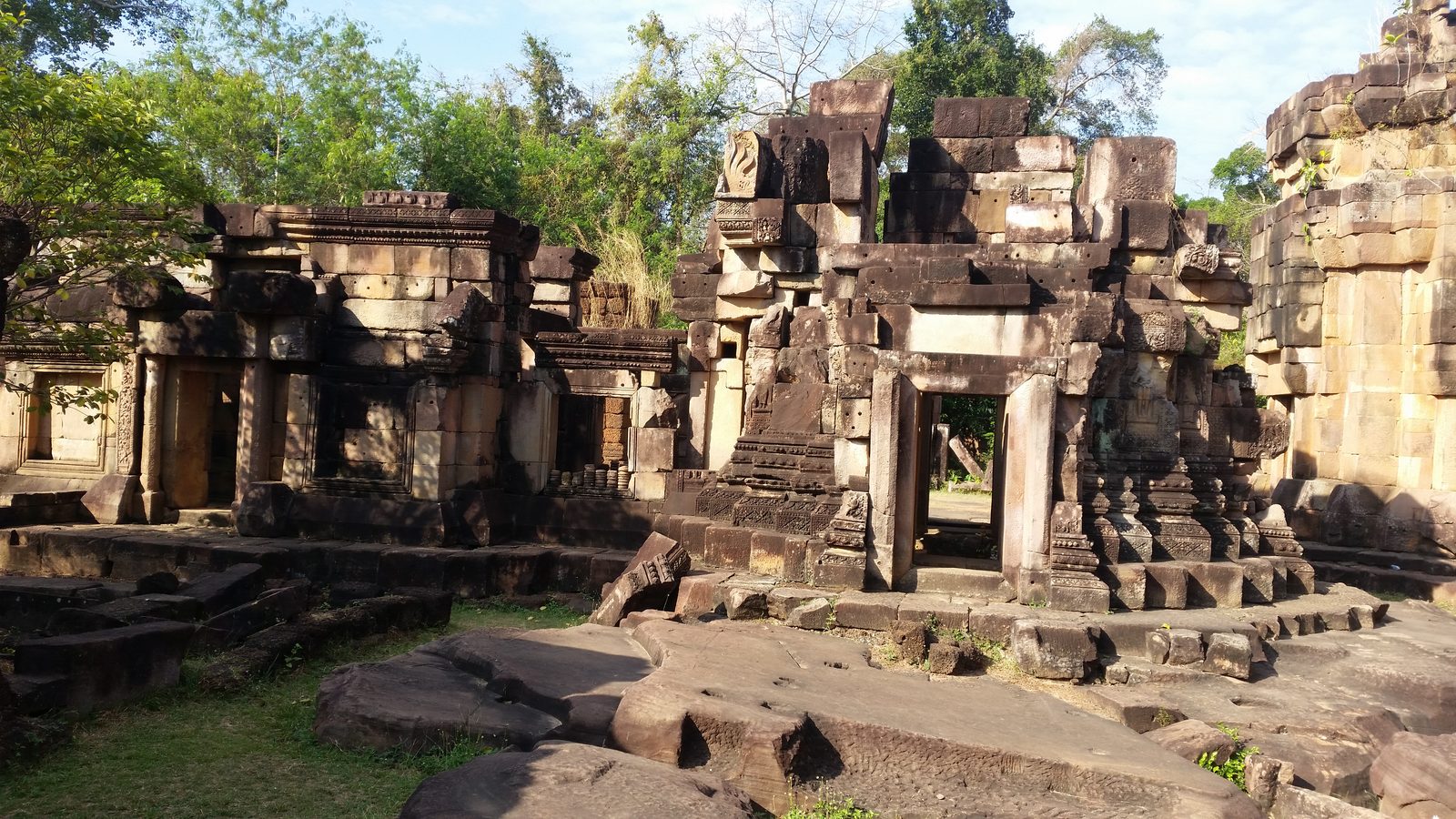 Ancient Khmer-style stone temple ruins surrounded by jungle in Thailand